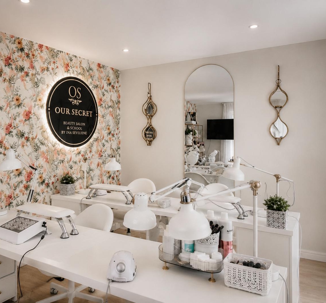 Our Secret salon interior with manicure stations and logo wall